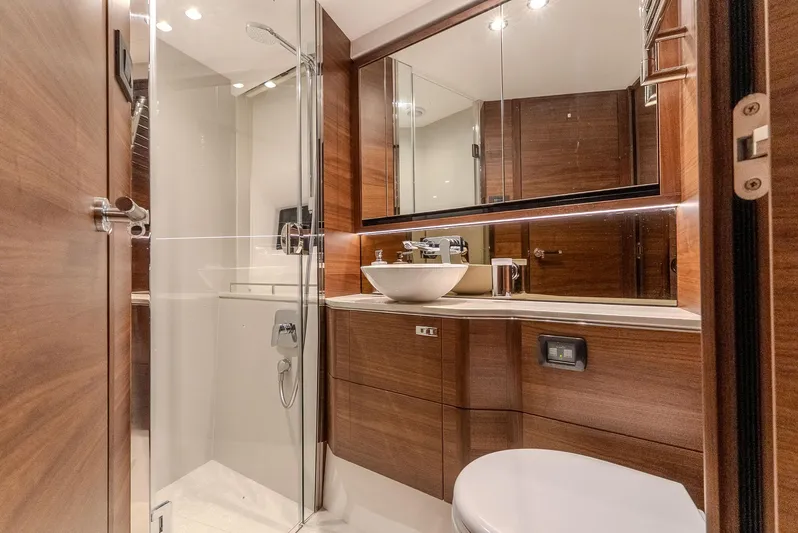  Yacht Photos Pics Luxurious bathroom in 2024 Princess F55 yacht with modern fixtures and wooden accents.