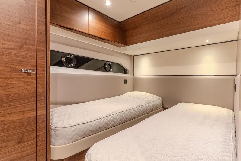  Yacht Photos Pics Luxurious twin cabin interior of 2024 Princess F55 yacht with wooden finishes.