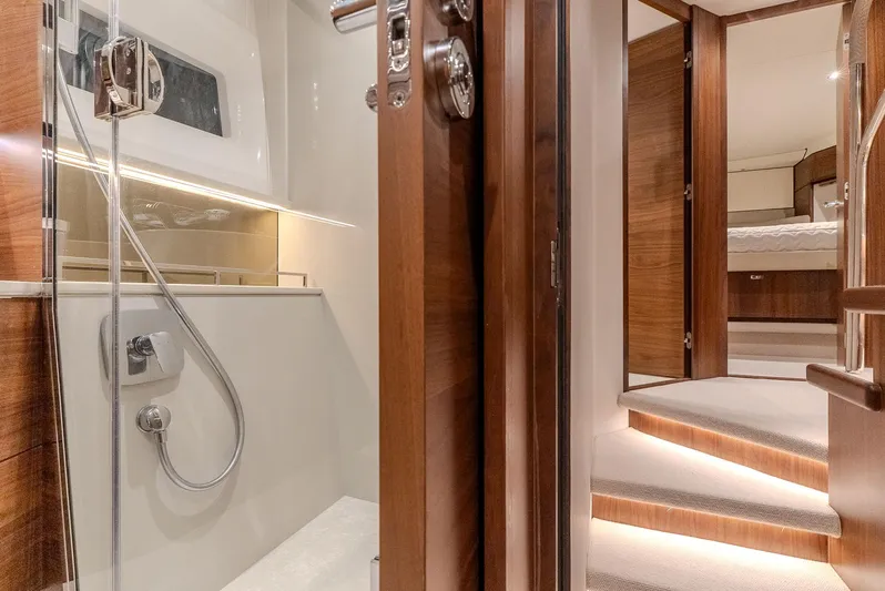  Yacht Photos Pics Luxurious interior of 2024 Princess F55 yacht, featuring elegant wood finishes and modern shower.