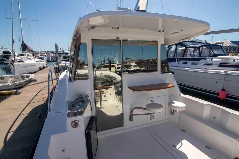  Yacht Photos Pics 2026 Aspen C100 yacht docked at marina, showcasing sleek design and spacious deck area.