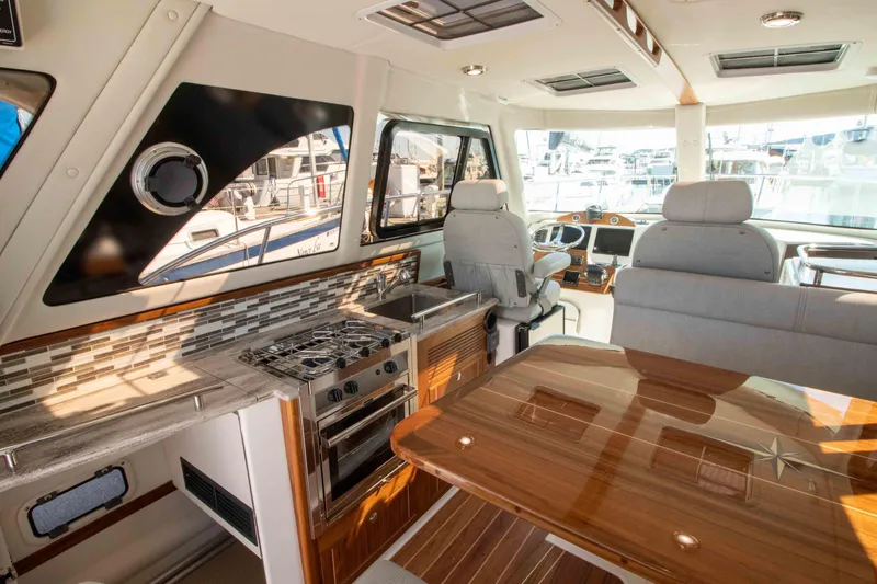  Yacht Photos Pics Luxurious interior of 2026 Aspen C100 yacht with modern kitchen and seating area.