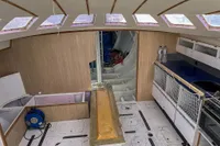 Interior of a 1999 Custom Open 50 sailboat with modern amenities and spacious layout.