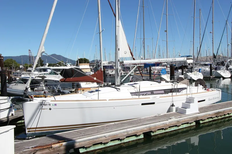  Yacht Photos Pics 2014 Jeanneau 379 sailboat docked at marina, clear sky, mountain backdrop.