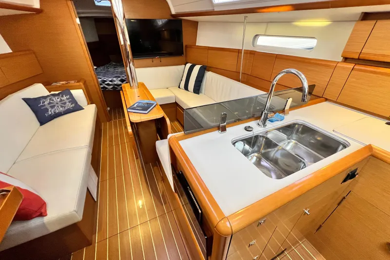  Yacht Photos Pics Interior of 2014 Jeanneau 379 yacht with modern kitchen and cozy seating area.