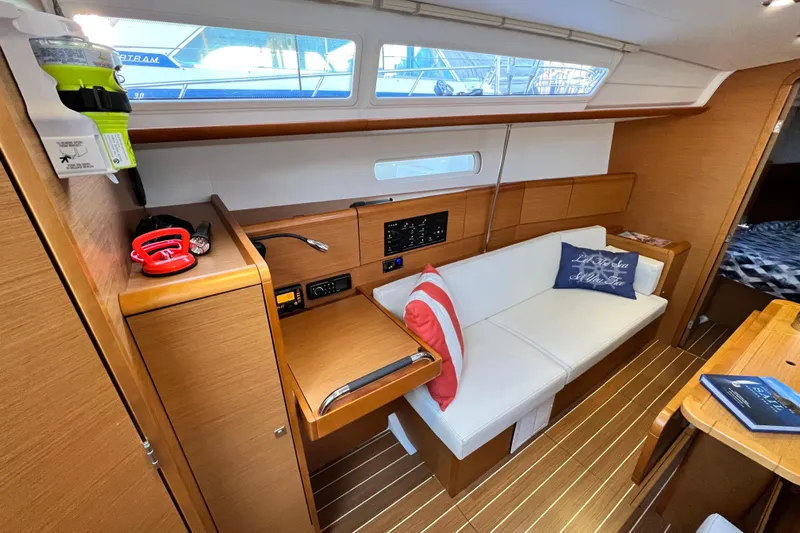  Yacht Photos Pics Interior of 2014 Jeanneau 379 sailboat with cozy seating and wooden finishes.