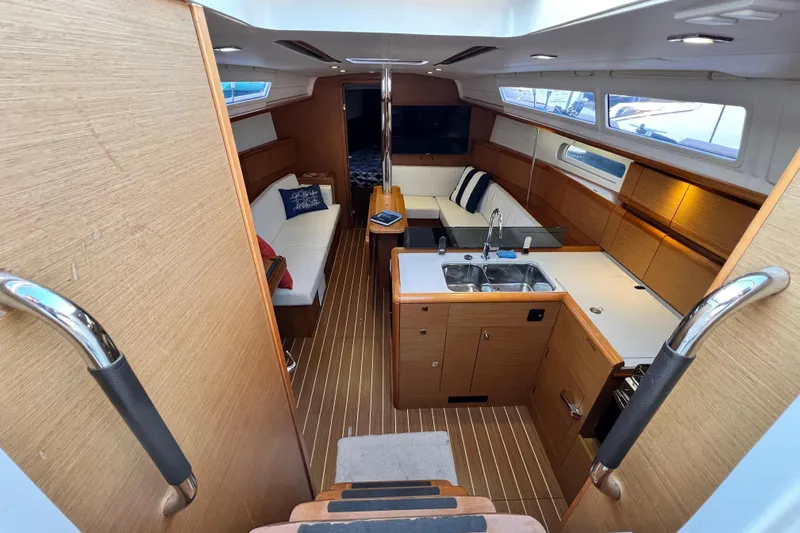  Yacht Photos Pics Interior of 2014 Jeanneau 379 sailboat with modern kitchen and cozy seating area.