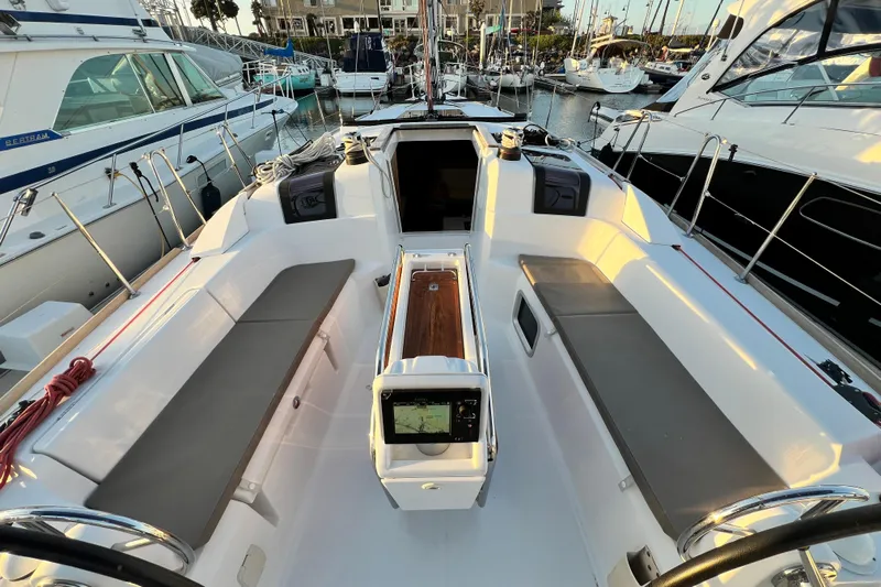  Yacht Photos Pics 2014 Jeanneau 379 sailboat cockpit with seating, navigation equipment, and marina view.