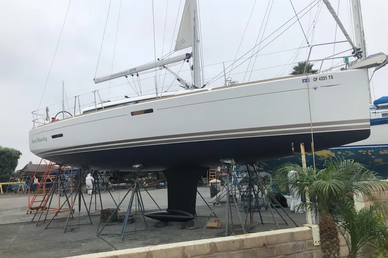  Yacht Photos Pics 2014 Jeanneau 379 sailboat on dry dock, supported by stands, with visible rigging.