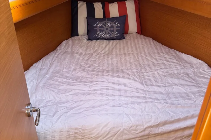  Yacht Photos Pics Cozy cabin bed in 2014 Jeanneau 379 sailboat with nautical-themed pillow.