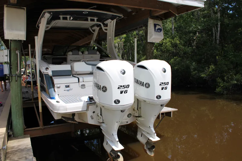 Yacht Photos Pics 2021 Chaparral 280 OSX boat with twin Yamaha 250 V6 engines docked in a marina.