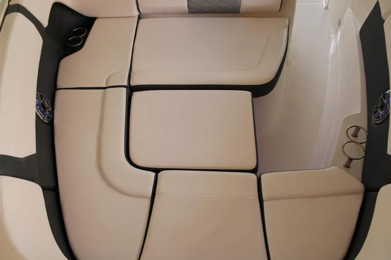  Yacht Photos Pics 2021 Chaparral 280 OSX boat interior with beige cushioned seating and cup holders.