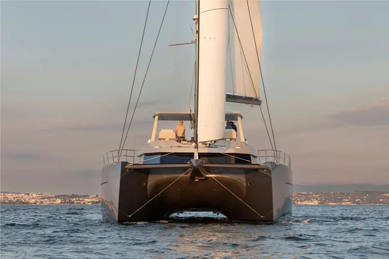 Elif Yacht Photos Pics 2022 Soyaslan CAT63 catamaran sailing on calm waters at sunset.