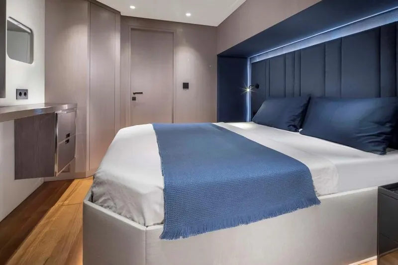 Elif Yacht Photos Pics Luxurious bedroom in 2022 Soyaslan CAT63 yacht, featuring modern design and blue accents.