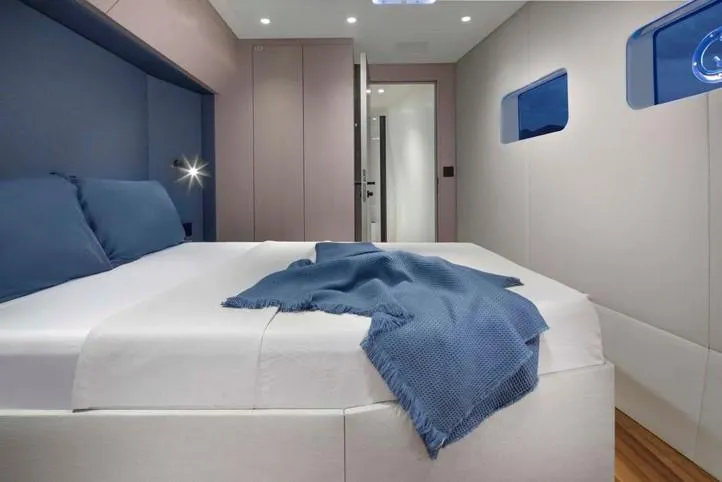 Elif Yacht Photos Pics Luxurious bedroom interior of 2022 Soyaslan CAT63 yacht with modern design and blue accents.