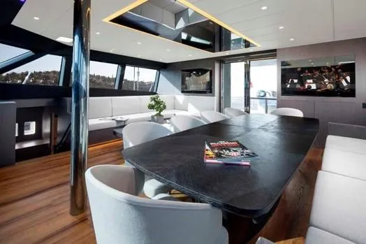 Elif Yacht Photos Pics Luxurious interior of 2022 Soyaslan CAT63 yacht with modern dining area and panoramic windows.