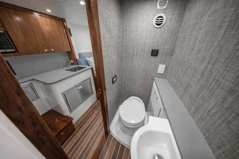 Kingston Grey Yacht Photos Pics Manufacturer Provided Image: Interior of 2026 Albemarle 41 Carolinian Fisharound Express, featuring modern bathroom and kitchenette.