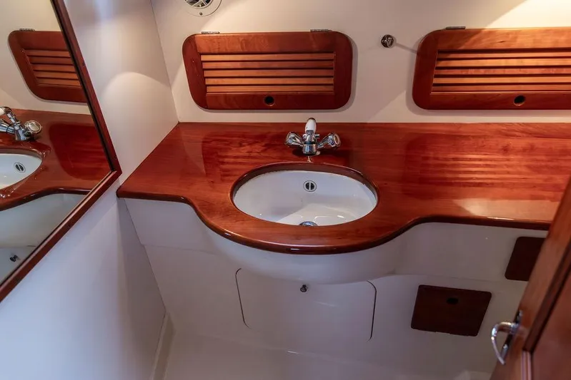 Zuzu Yacht Photos Pics Luxurious wooden vanity in 2004 Hinckley Picnic Boat EP bathroom.