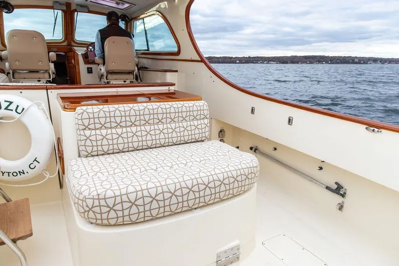 Zuzu Yacht Photos Pics 2004 Hinckley Picnic Boat EP interior with patterned seating, cruising on open water.