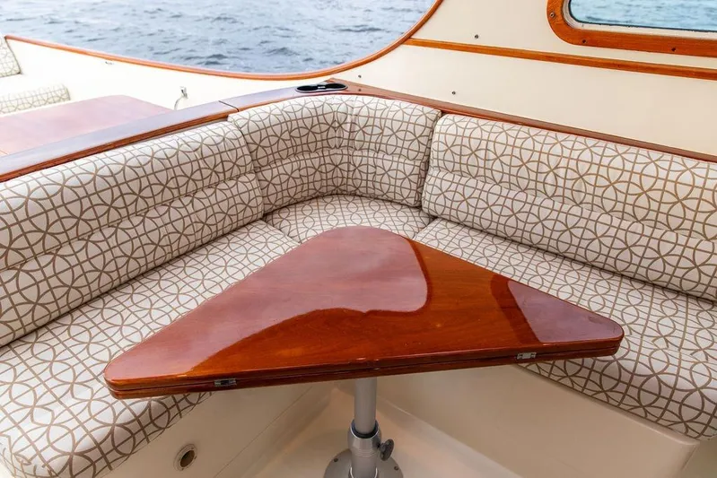 Zuzu Yacht Photos Pics 2004 Hinckley Picnic Boat EP interior with patterned seating and polished wooden table.