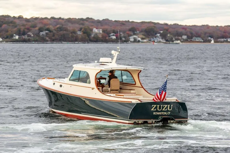 Zuzu Yacht Photos Pics 2004 Hinckley Picnic Boat EP cruising on a scenic lake with autumn foliage.