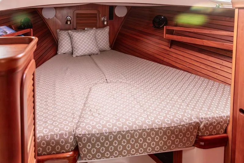 Zuzu Yacht Photos Pics 2004 Hinckley Picnic Boat EP cabin with cozy bed and wooden interior.