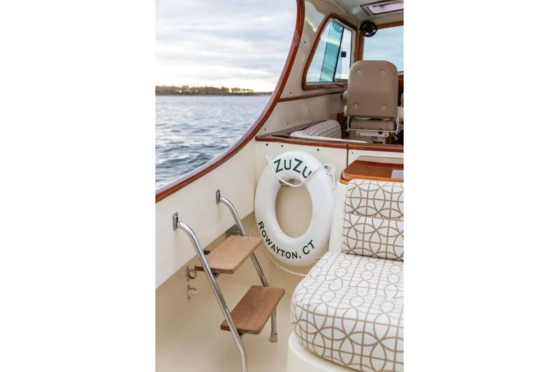 Zuzu Yacht Photos Pics 2004 Hinckley Picnic Boat EP interior with patterned seating and life preserver.