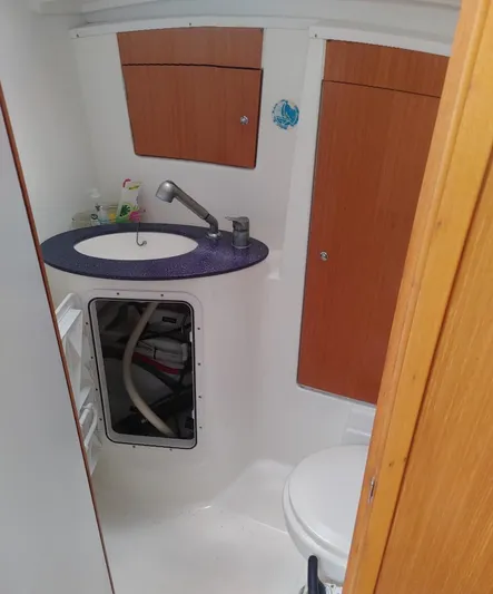 Blue Nomade Yacht Photos Pics Bathroom interior of 2006 Beneteau Cyclades 50.4 yacht with sink and storage cabinets.