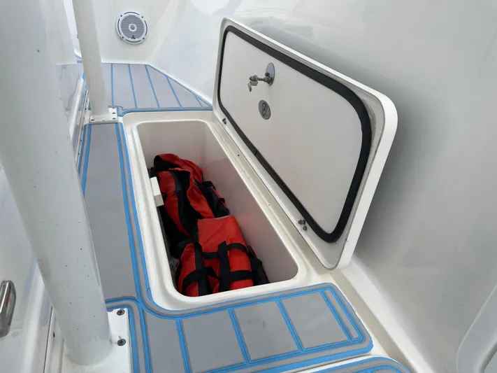 Intensity 2 Yacht Photos Pics Storage compartment on 2015 Century 2901 Center Console boat with life jackets inside.
