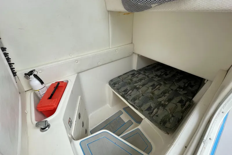 Intensity 2 Yacht Photos Pics 2015 Century 2901 Center Console cabin interior with cushioned seating and storage.