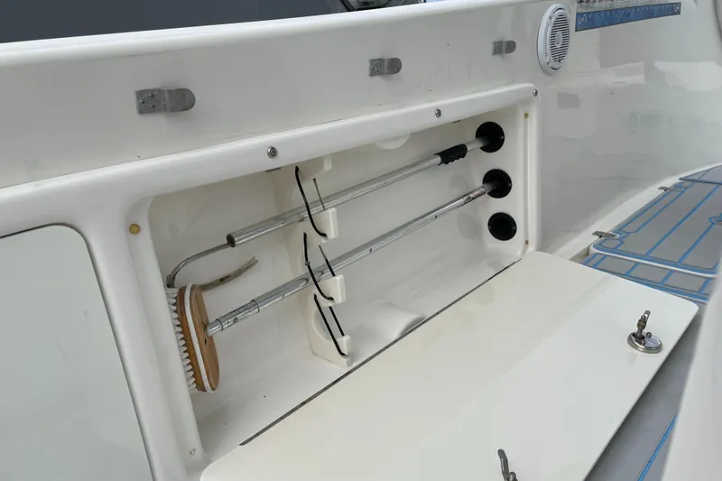 Intensity 2 Yacht Photos Pics 2015 Century 2901 Center Console boat storage compartment with cleaning tools.