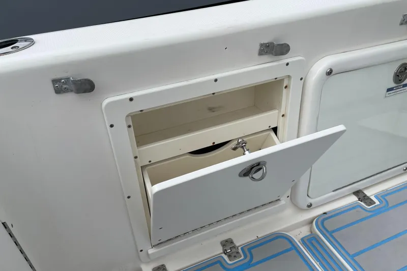 Intensity 2 Yacht Photos Pics 2015 Century 2901 Center Console storage compartment with open hatch and secure latch.