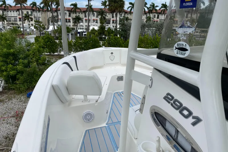 Intensity 2 Yacht Photos Pics 2015 Century 2901 Center Console boat docked near waterfront buildings and palm trees.