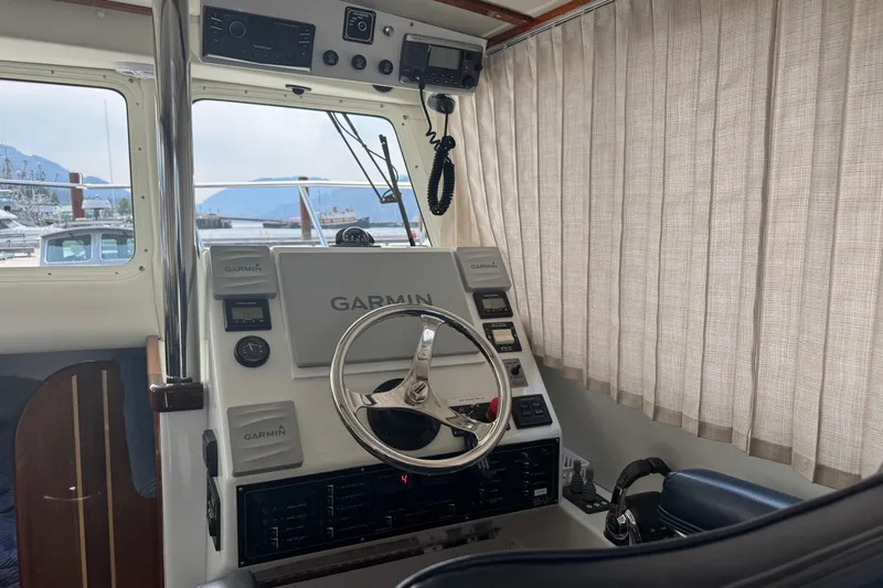  Yacht Photos Pics 2017 Ocean Sport Roamer helm with Garmin navigation system and steering wheel.