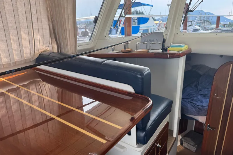 Yacht Photos Pics Interior of a 2017 Ocean Sport Roamer boat with polished wood and navigation equipment.