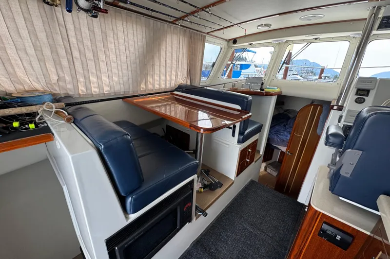  Yacht Photos Pics 2017 Ocean Sport Roamer interior with seating, table, and navigation equipment.