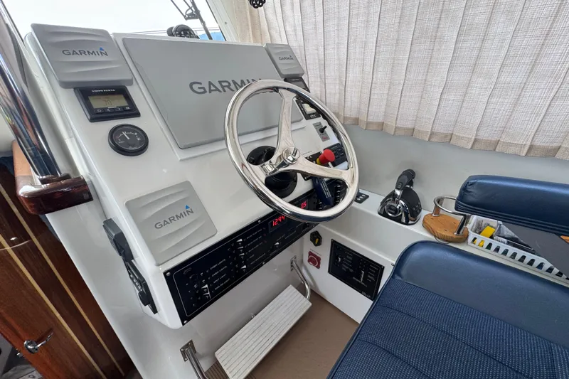  Yacht Photos Pics Cockpit of 2017 Ocean Sport Roamer with Garmin navigation system and steering wheel.