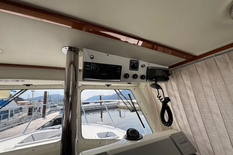  Yacht Photos Pics Interior view of 2017 Ocean Sport Roamer boat with navigation equipment and marina background.