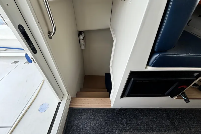  Yacht Photos Pics Interior stairs of 2017 Ocean Sport Roamer boat, featuring a compact design and safety equipment.