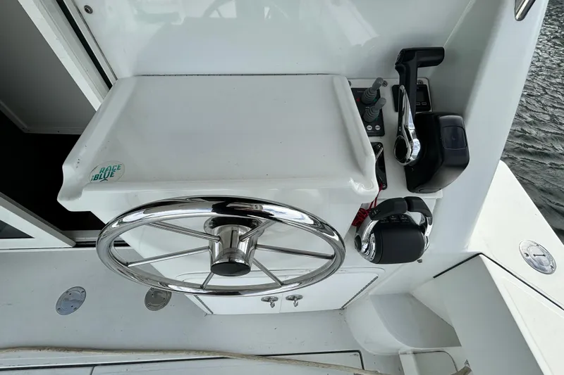  Yacht Photos Pics 2017 Ocean Sport Roamer boat helm with steering wheel and controls.