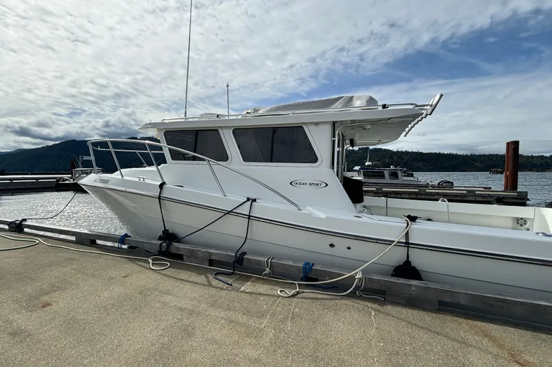  Yacht Photos Pics 2017 Ocean Sport Roamer boat docked at marina under cloudy sky.