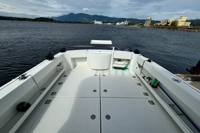  Yacht Photos Pics 2017 Ocean Sport Roamer boat deck with scenic water and mountain backdrop.