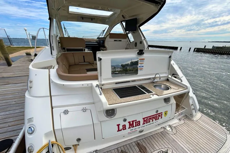  Yacht Photos Pics 2017 Sea Ray Sundancer 350 Coupe with outdoor kitchen, docked by the water.