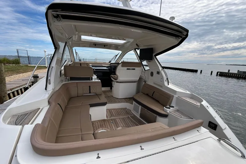  Yacht Photos Pics 2017 Sea Ray Sundancer 350 Coupe with spacious seating, docked by serene waters.