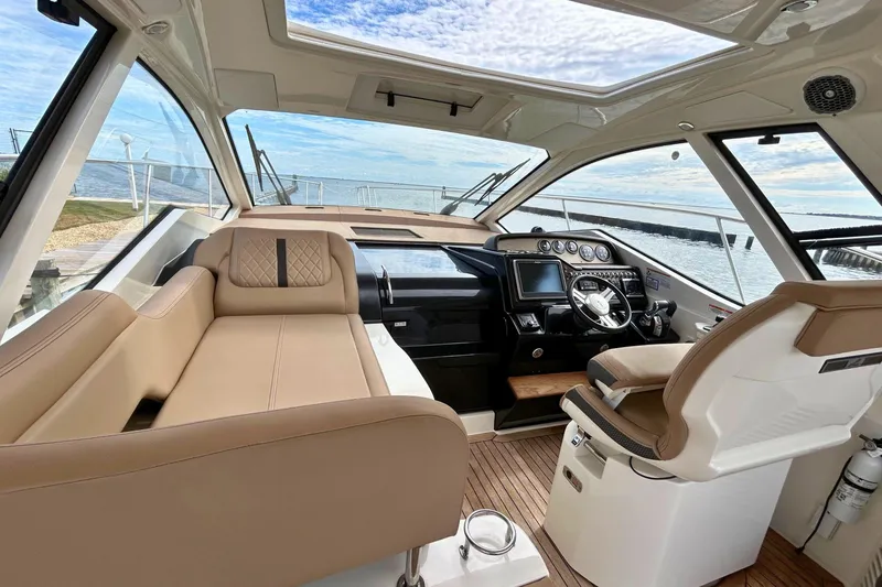 Yacht Photos Pics 2017 Sea Ray Sundancer 350 Coupe interior with luxurious seating and modern helm controls.
