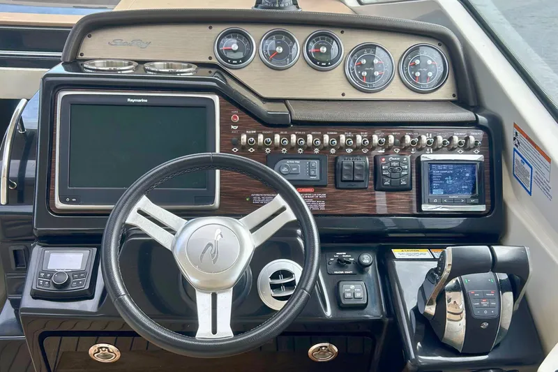  Yacht Photos Pics 2017 Sea Ray Sundancer 350 Coupe dashboard with steering wheel and control panel.