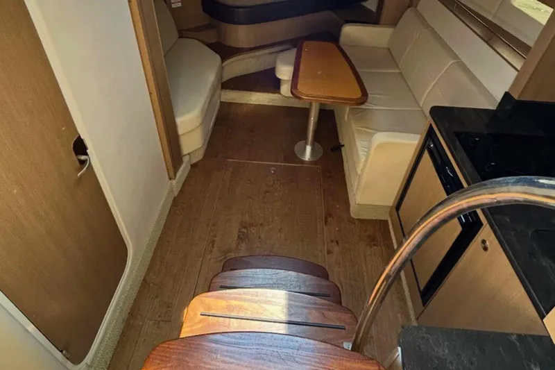  Yacht Photos Pics 2017 Sea Ray Sundancer 350 Coupe interior with wood flooring and cozy seating area.