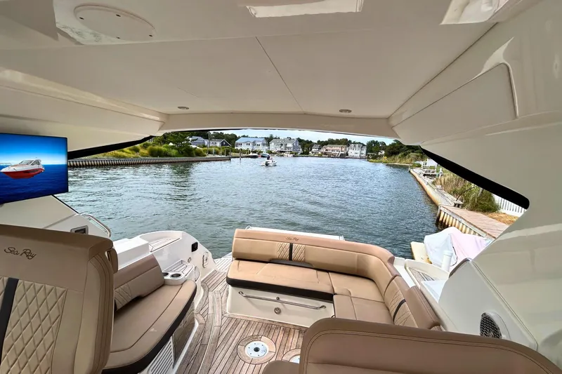  Yacht Photos Pics 2017 Sea Ray Sundancer 350 Coupe interior with waterfront view, featuring luxurious seating and a TV.
