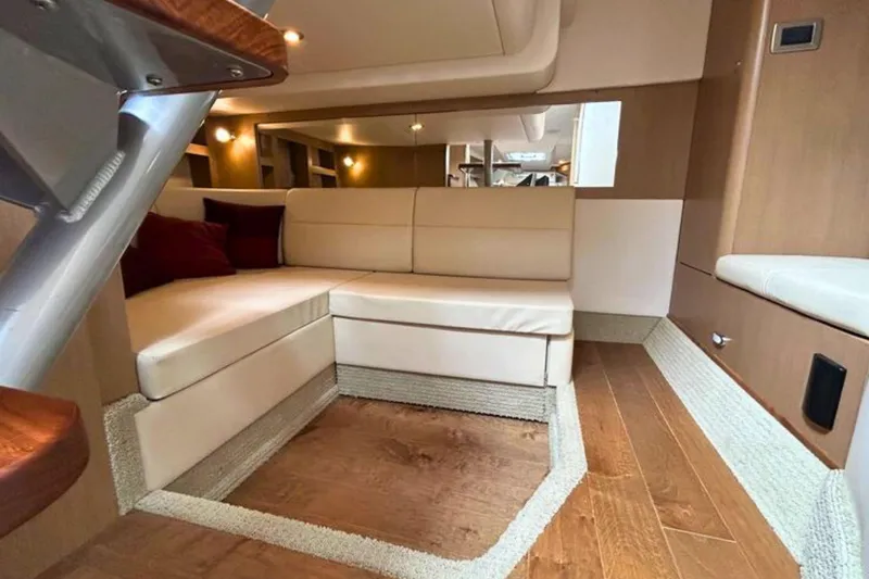  Yacht Photos Pics Interior of 2017 Sea Ray Sundancer 350 Coupe with beige seating and wooden flooring.