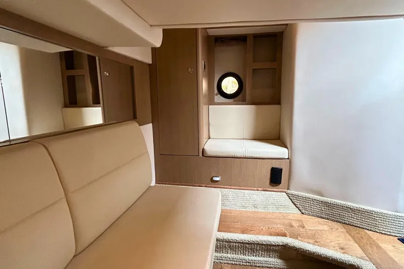 Yacht Photos Pics Interior of 2017 Sea Ray Sundancer 350 Coupe, featuring beige seating and wooden accents.