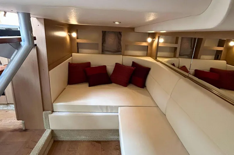  Yacht Photos Pics Luxurious interior of 2017 Sea Ray Sundancer 350 Coupe with cream seating and red cushions.